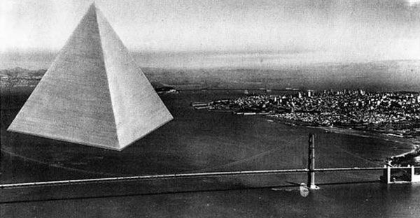A black-and-white photograph shows a large, floating pyramid hovering over water, with a cityscape and bridge in the background.