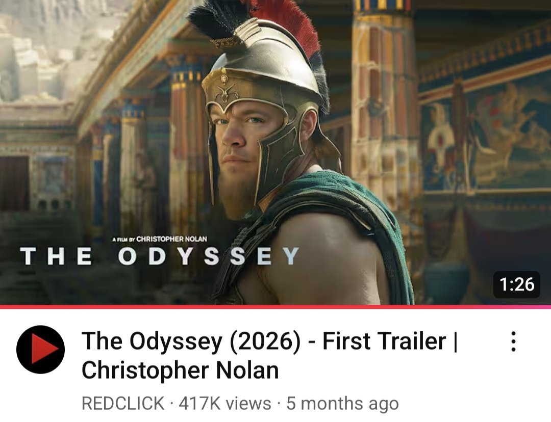 A muscular man in ancient Greek armor with a red-and-black plume on his helmet stands in a grand, ornately decorated hall. The text "THE ODYSSEY" and "A FILM BY CHRISTOPHER NOLAN" appear above him, with a YouTube video title below indicating a 2026 movie trailer.